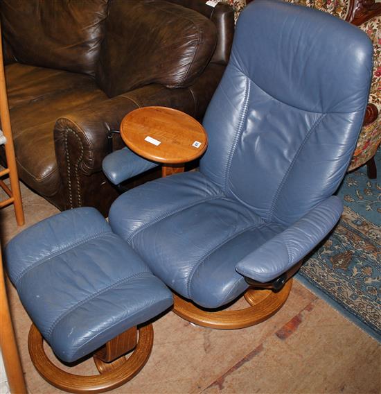 Modern armchair in blue vinyl with matching foot stool